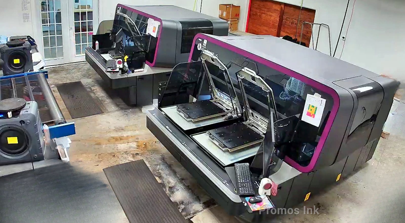 Kornit Atlas MAX industrial DTG printers and Kornit pretreatment units in Promos Ink's DTG department